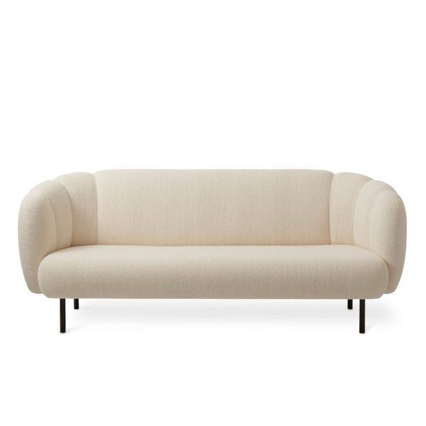En moderne cremefarvet sofa med en minimalistisk designmøbler, med afrundede armlæn og tynde sorte ben, isoleret på en hvid baggrund.