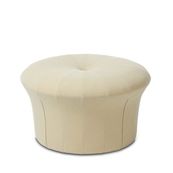 En lys beige skammel med et stofbetrukket, plisseret design, isoleret på en hvid baggrund. Skammelen har en rund, let foldet form, der ligner en stor pude.