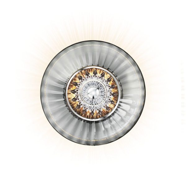En dekorativ loftmonteret lampe med cirkulær, sølv og krystalmøbler med udstrålende mønstre af gennemskinnelige og metalliske elementer, der udsender en varm glød.