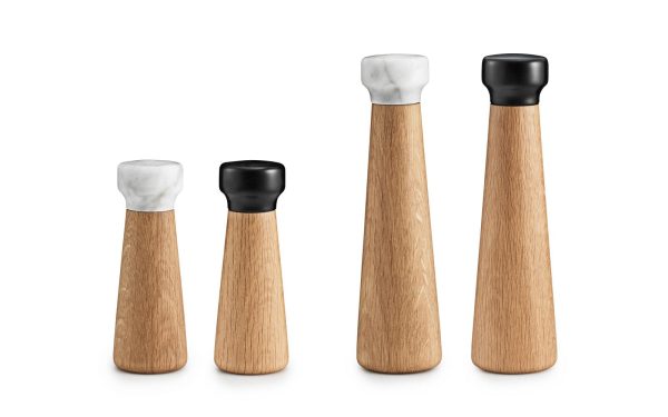 Fire NORMANN COPENHAGEN Craft Peberkværn krydderikværne med to forskellige farvede toppe, to i sort og to i hvid, arrangeret på række på hvid baggrund.