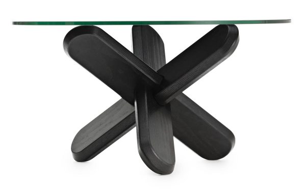 Et moderne designbord med en klar glasplade og en distinkt, skulpturel sort base dannet af sammenlåsende buede former, isoleret mod en hvid baggrund.