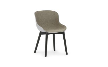 En moderne NORMANN COPENHAGEN - Hyg Spisebordsstol med gråt polstret sæde og ryglæn, og en blank hvid skal. den står på fire sorte, slanke træben, isoleret mod en hvid baggrund.