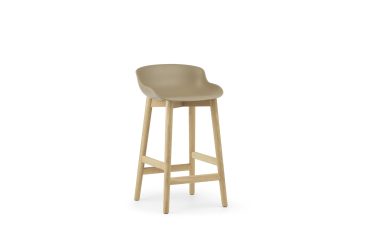 En moderne beige barstol med træben og et glat, buet sæde, designet til moderne interiør, isoleret på en hvid baggrund.