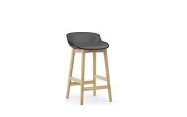 En moderne barstol med sort sæde og lyse træben på en hvid baggrund, der fremviser slankt design.