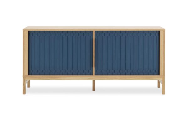 En moderne træskænk med en naturlig egetræsfinish, med to marineblå sprossede skydedøre og stående på fire vinklede ben. Smykket, der er ideelt for designmøbler-entusiaster, er fotograferet mod en almindelig hvid baggrund.
