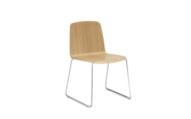 A NORMANN COPENHAGEN - Just Stol med buet krydsfinersæde og ryglæn monteret på en elegant krom slædebase, mod en almindelig hvid baggrund.