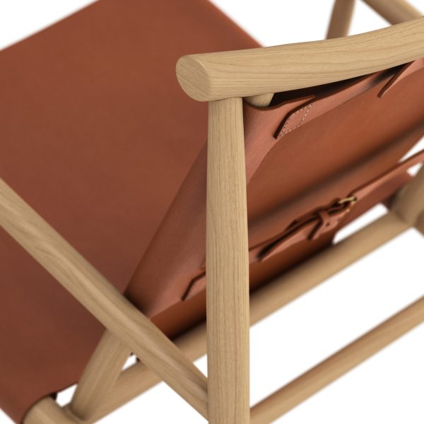 Nærbillede af en moderne loungestol med et træstel med glatte, afrundede arme og et stramt lædersejlesæde og -ryglæn i en rig terracotta-farve. Dette stykke eksemplificerer det innovative design, der er karakteristisk for TomorrowsDesign.