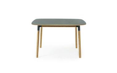 Et moderne bord med en rektangulær, mørkegrå overflade oven på fire slanke træben fra TomorrowsDesign, isoleret mod en hvid baggrund.