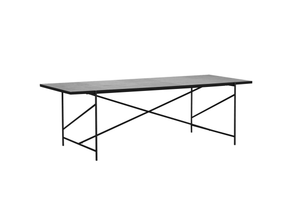 Et enkelt rektangulært bord med en tekstureret grå plade og et sort metalstel med x-formede ben, sat mod en solid grøn baggrund fra TomorrowsDesign.