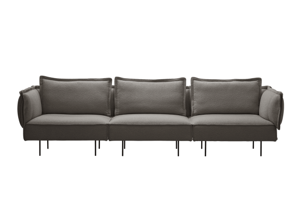 En moderne grå sektionssofa med plyshynder og tynde sorte ben, designet af TomorrowsDesign, sat mod en solid grøn baggrund.