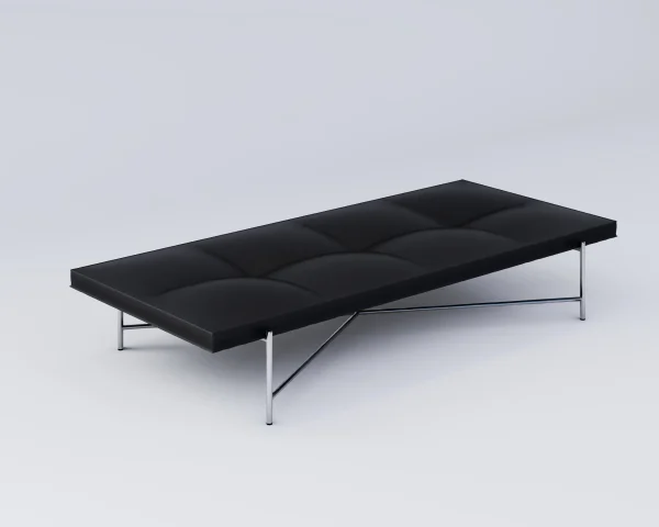 A HANDVÄRK - Daybed med minimalistisk metalramme, sat mod en almindelig lysegrå baggrund. Daybeden har et tuftet polstringsdesign.
