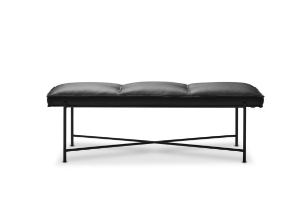 En moderne bænk i sort læder med en polstret top og en metalbund med x-ramme, med et slankt design, isoleret på en hvid baggrund.