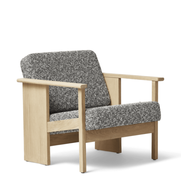 En moderne lænestol med lys træramme og gråplettet polstring, isoleret på sort baggrund. Designmøbleren har rene linjer og et behageligt, tykt polstret sæde og ryglæn.