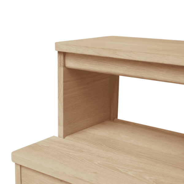 Et enkelt træbord med en glat finish, med en øvre og en nedre hylde. Skrivebordet er placeret mod en solid sort baggrund, hvilket understreger dets rene linjer og minimalistiske design af TomorrowsDesign.