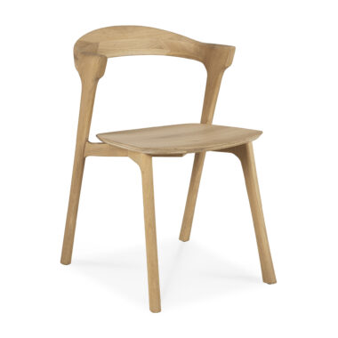 En Bok spisestuestol - eg med buet ryglæn og fire ben. Sæde og ryglæn er sømløst integreret i stellet og viser et minimalistisk og moderne design. Træet har en let, naturlig finish.
